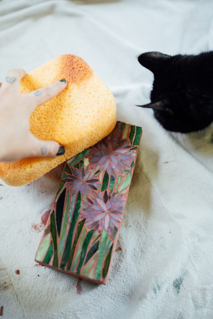 Stained glass scrap mosaic on brick